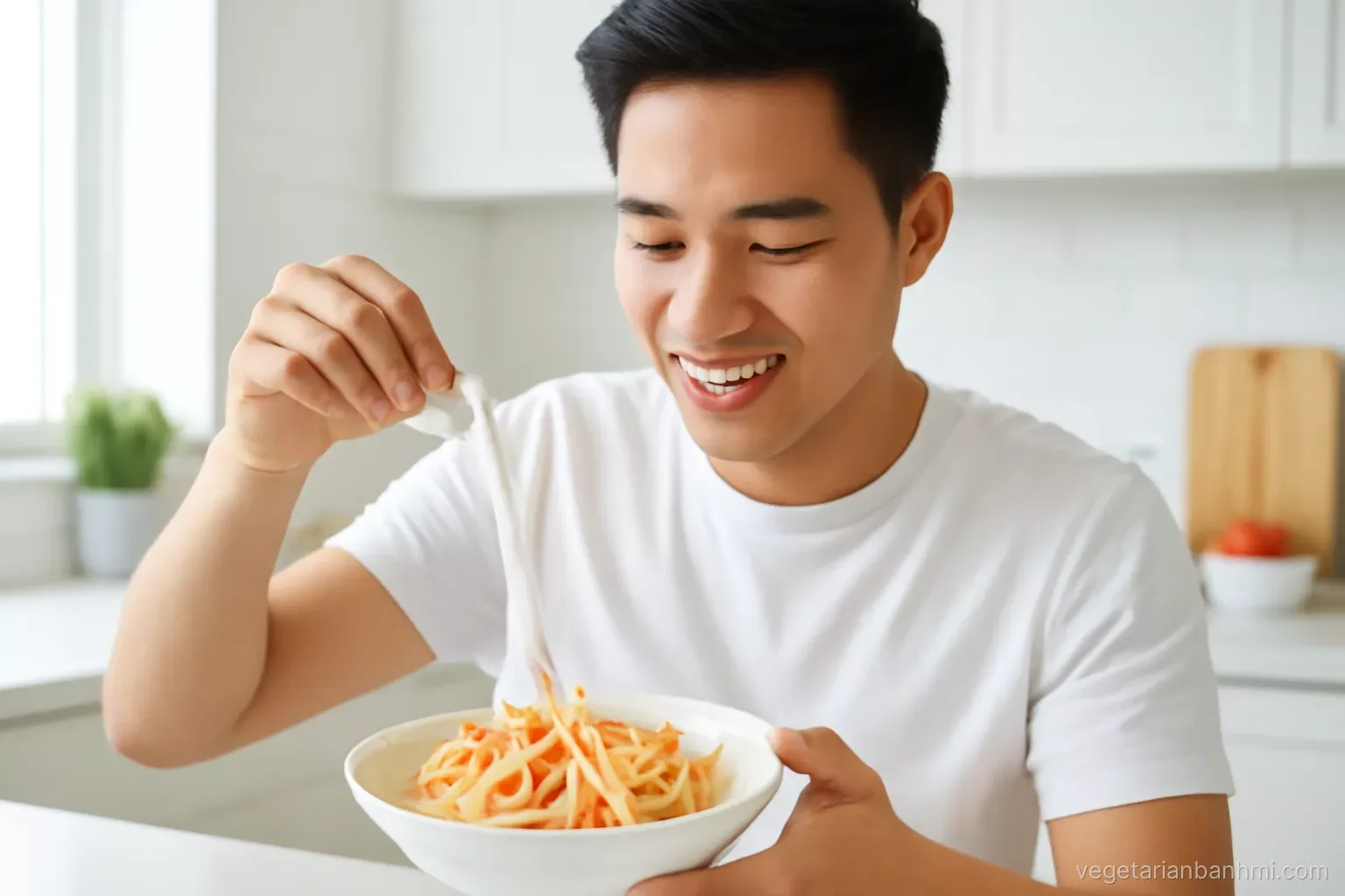 Young Vietnamese man in a bright modern kitchen bending a salted daikon stick into a U shape over a bowl of carrot and daikon matchsticks, close-up, crisp side light.